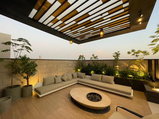 Rooftop lounge with pergola, planting and fire pit