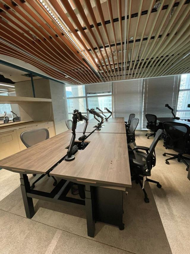 Workstations under a timber-slat ceiling